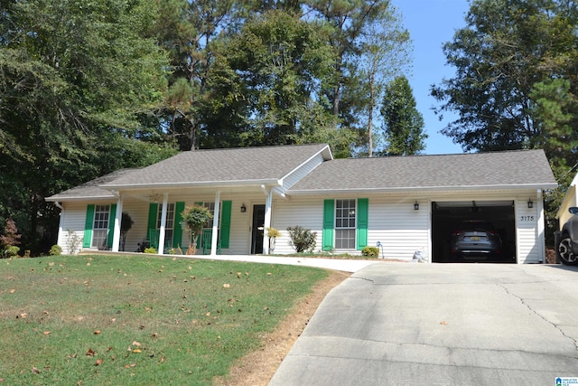 single story home featuring a garage, covered porch, and a front lawn