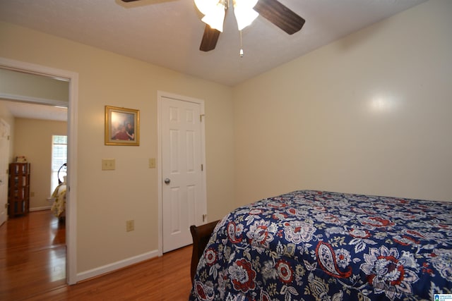 bedroom featuring hardwood / wood-style floors and ceiling fan