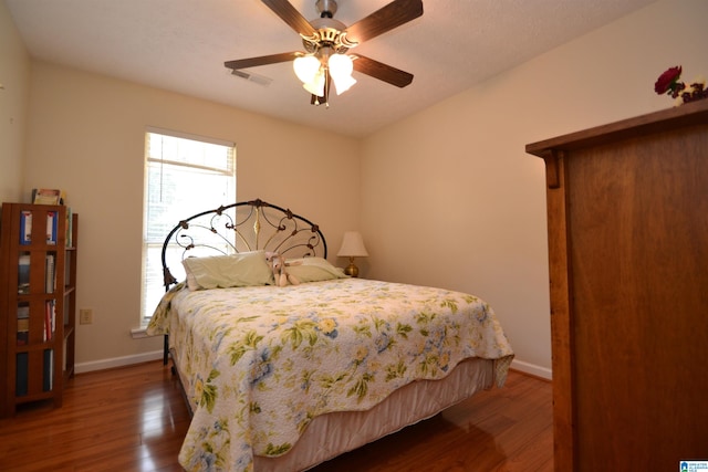 bedroom featuring ceiling fan and dark hardwood / wood-style floors