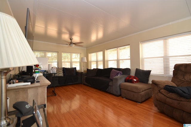 living room featuring crown molding, hardwood / wood-style floors, and ceiling fan