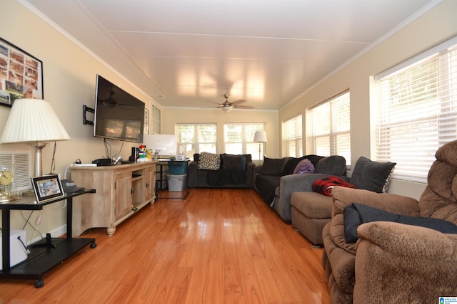 living room featuring wood-type flooring, ceiling fan, and ornamental molding