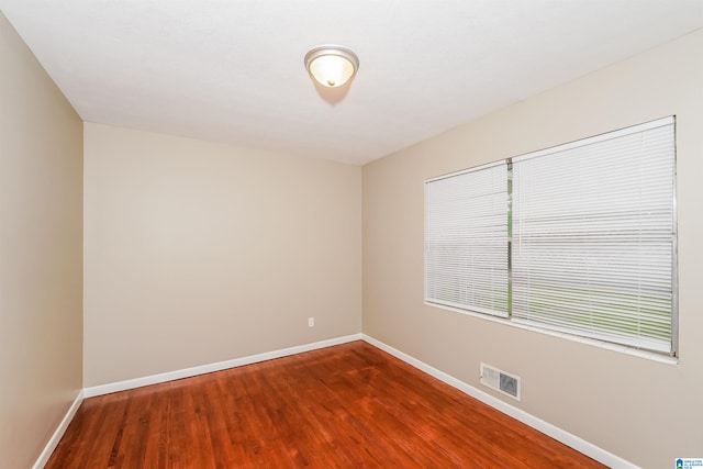 unfurnished room with wood-type flooring