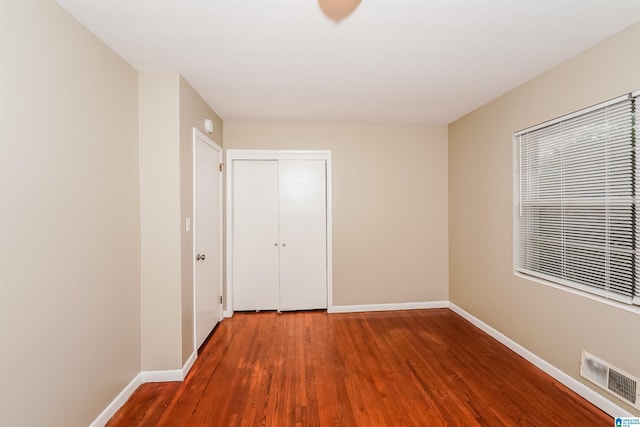 unfurnished bedroom featuring a closet and wood-type flooring