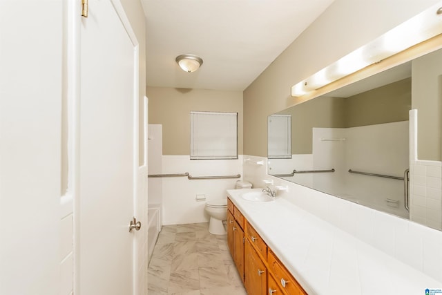 bathroom featuring vanity, toilet, and backsplash