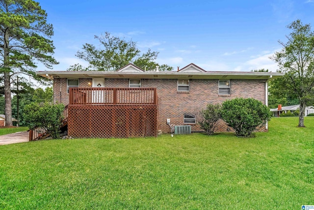 rear view of property featuring a yard and a wooden deck