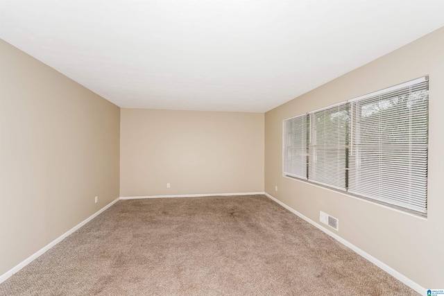 spare room with light colored carpet