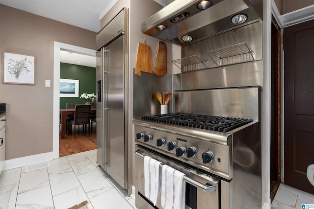 kitchen with high quality appliances and ventilation hood