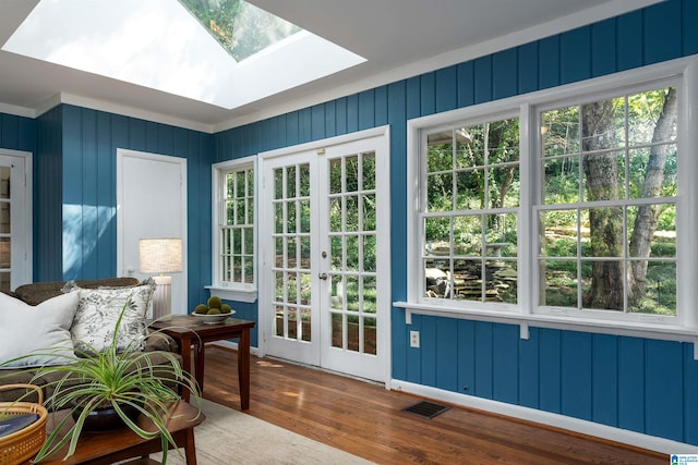 sunroom with french doors, a skylight, and a healthy amount of sunlight