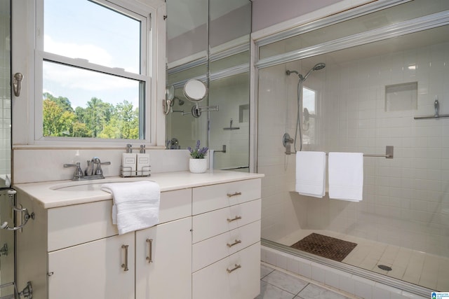 bathroom with vanity, plenty of natural light, an enclosed shower, and tile patterned floors