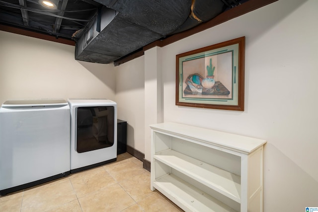 clothes washing area with separate washer and dryer and light tile patterned floors