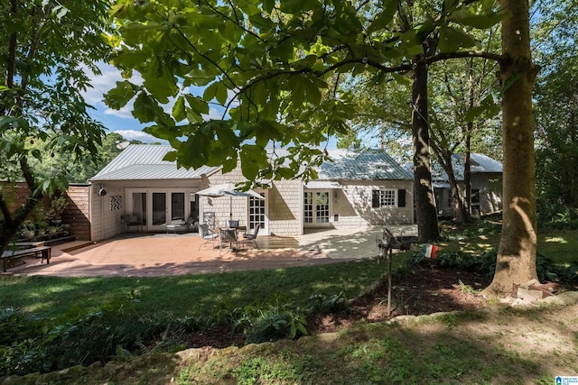 rear view of house with a patio and french doors