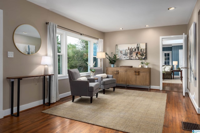 living area featuring french doors and dark hardwood / wood-style flooring