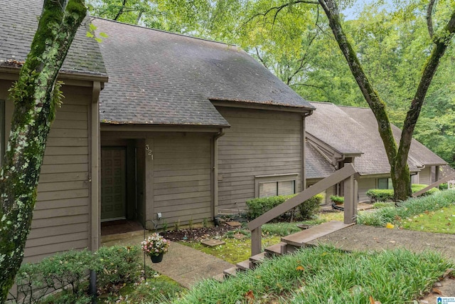 view of home's exterior with a shingled roof