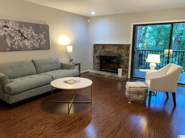 living room with dark hardwood / wood-style floors and a fireplace