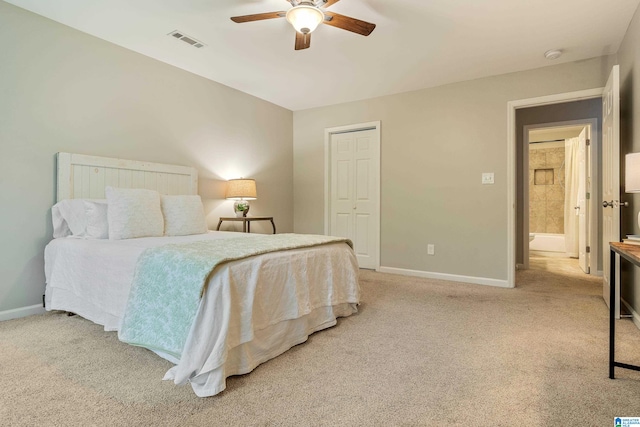 bedroom with a closet, ceiling fan, and light carpet