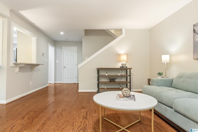 living area with stairs, recessed lighting, wood finished floors, and baseboards