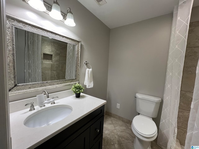 bathroom featuring tile patterned floors, a shower with shower curtain, toilet, and vanity