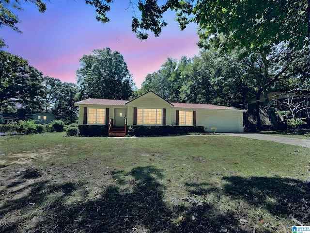 view of front of property featuring a yard and a garage