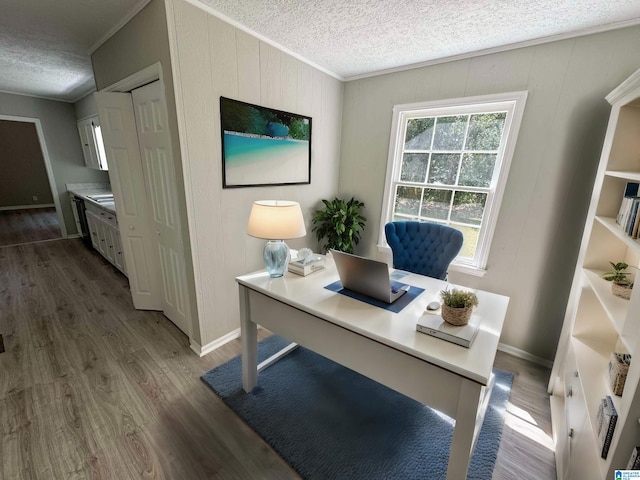 office space with crown molding, a textured ceiling, wooden walls, and dark hardwood / wood-style floors