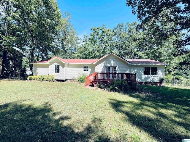 view of front of home featuring a front yard and a wooden deck