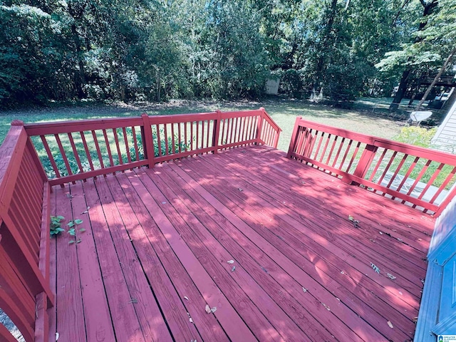 wooden terrace featuring a lawn