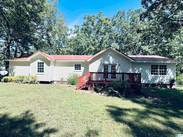 single story home with a front yard and a deck