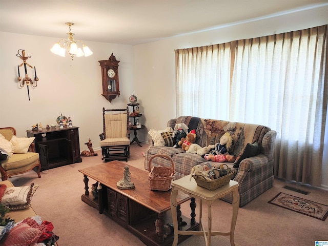 living room featuring carpet flooring and an inviting chandelier