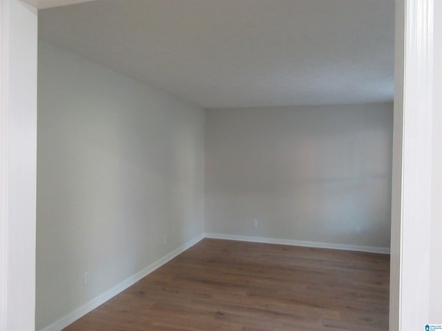 unfurnished room with hardwood / wood-style flooring