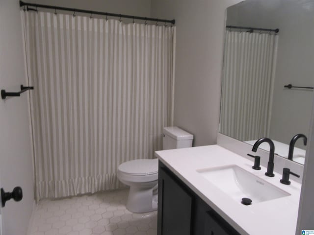 bathroom with vanity, toilet, a shower with curtain, and tile patterned floors