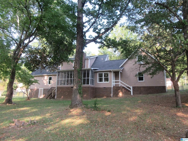 back of property featuring a yard and a sunroom