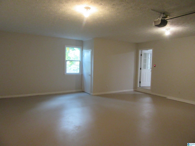 spare room featuring concrete floors and a textured ceiling