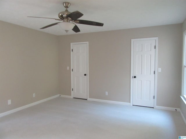 spare room with light carpet and ceiling fan