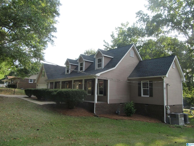 cape cod-style house with a front lawn and central air condition unit