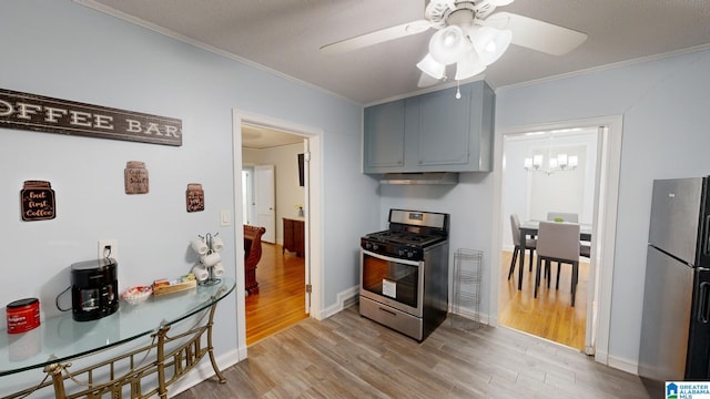 kitchen with a textured ceiling, light hardwood / wood-style flooring, ceiling fan with notable chandelier, appliances with stainless steel finishes, and ornamental molding