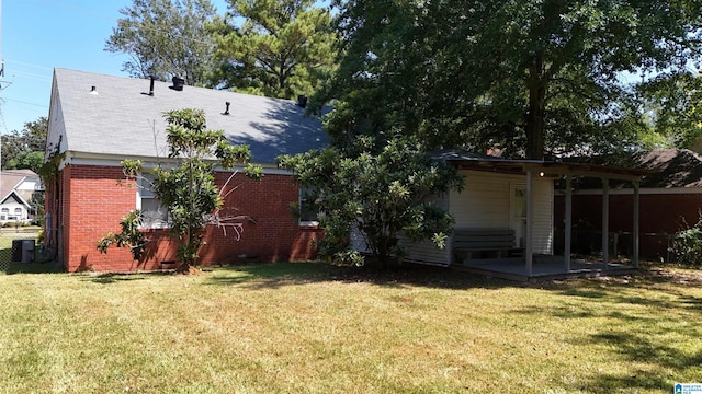 rear view of house with a yard and a patio