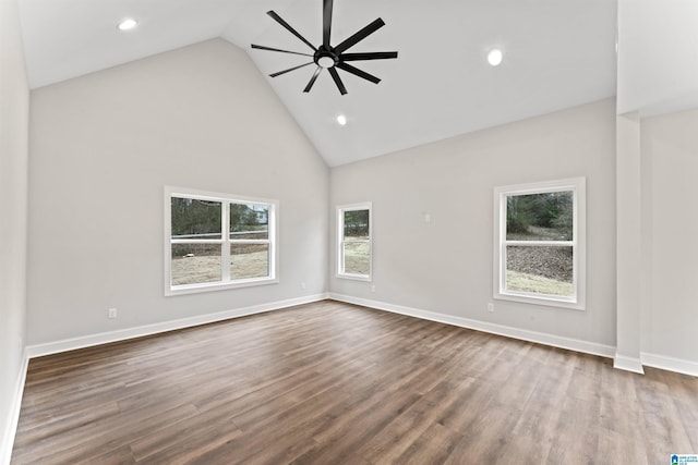 empty room featuring dark wood finished floors, a ceiling fan, baseboards, and high vaulted ceiling