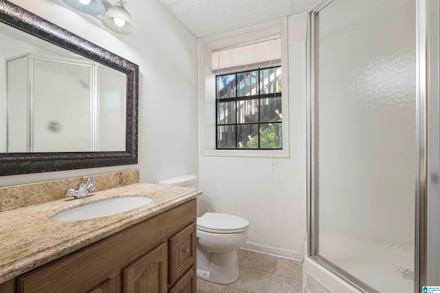 bathroom featuring a textured ceiling, toilet, vanity, an enclosed shower, and tile patterned flooring