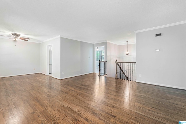 empty room with crown molding, ceiling fan, and dark hardwood / wood-style flooring