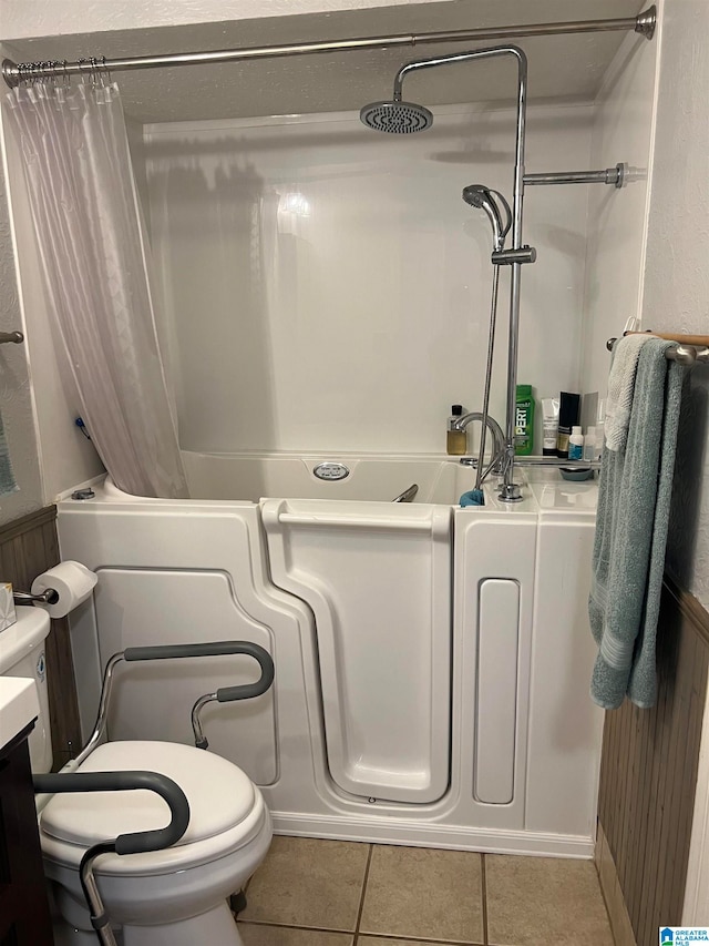 full bathroom featuring tile patterned flooring, vanity, toilet, and shower / bath combo with shower curtain