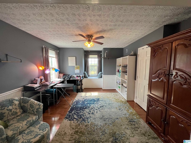 interior space featuring a textured ceiling, dark hardwood / wood-style flooring, and ceiling fan