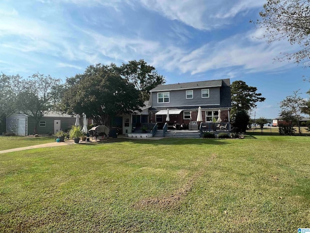 view of front facade featuring a deck and a front lawn