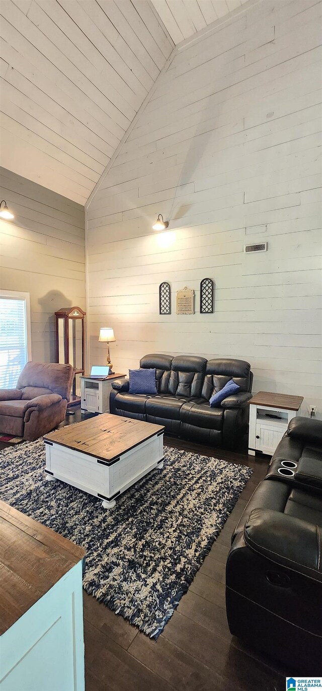 living area with wood ceiling, wood finished floors, wooden walls, and high vaulted ceiling