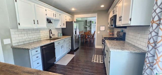 kitchen with white cabinets, dishwashing machine, dark wood finished floors, and stainless steel fridge