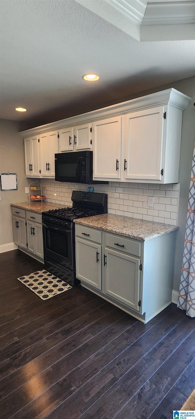 kitchen featuring black appliances, dark hardwood / wood-style floors, backsplash, and white cabinetry