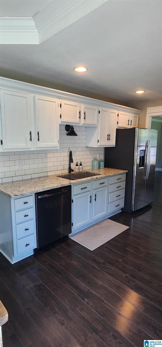 kitchen featuring dark wood-style flooring, baseboards, white cabinetry, backsplash, and black appliances