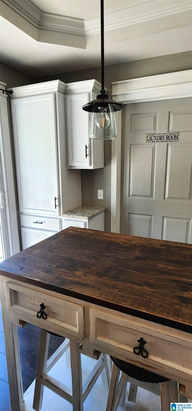 unfurnished dining area featuring crown molding