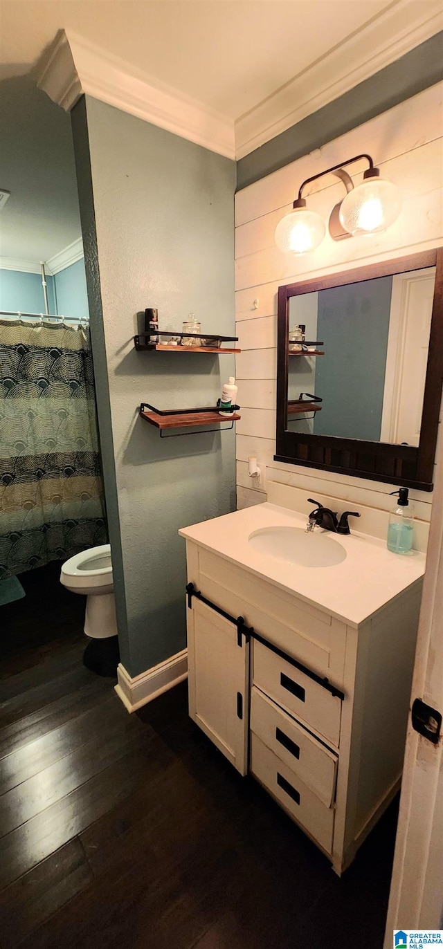 bathroom with toilet, crown molding, vanity, curtained shower, and hardwood / wood-style flooring