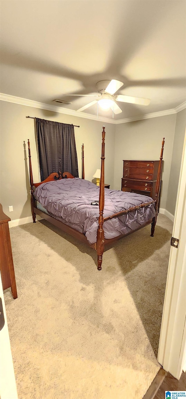 bedroom featuring carpet, baseboards, ornamental molding, and a ceiling fan