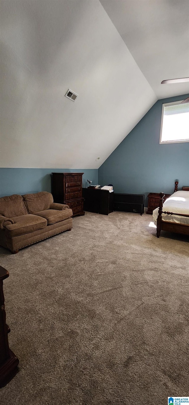 interior space with baseboards, a ceiling fan, carpet, and lofted ceiling