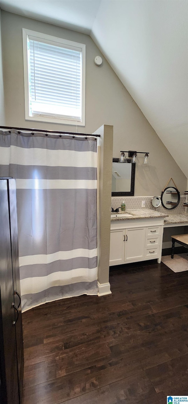 bathroom featuring visible vents, baseboards, toilet, vaulted ceiling, and wood finished floors